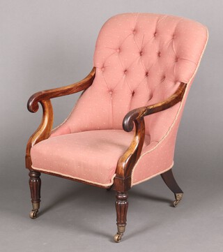 A William IV rosewood show frame open arm chair upholstered in pink material, raised on turned and reeded supports with brass caps and casters 