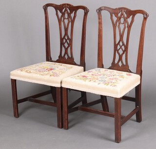A pair of 19th century Chippendale style splat back dining chairs with pierced vase shaped slat backs and overstuffed seats upholstered in Berlin wool work 