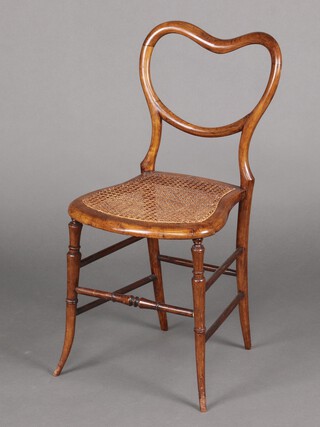 A Victorian beech spoon back bedroom chair, with shaped mid rail and woven cane seat, raised on turned supports with turned stretchers  