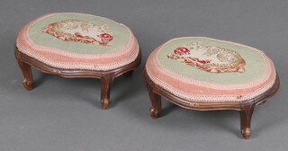A pair of Victorian oval carved mahogany stools, the seats upholstered in Berlin wool work decorated cats 13cm h x 32cm w x 26cm d 
