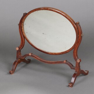 A 19th century oval plate dressing table mirror contained in a mahogany swing frame 47cm h x 47 cm w x 26cm d 