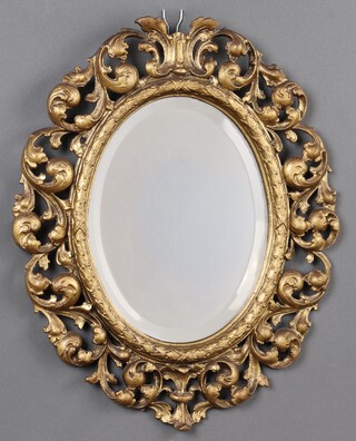 A 19th century oval bevelled plate mirror contained in a pierced gilt painted cast metal frame 45cm 