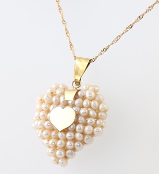 A gold marked 750 chain 44cm, hung a pearl set pendant with gilt metal mounts, 6.1g gross