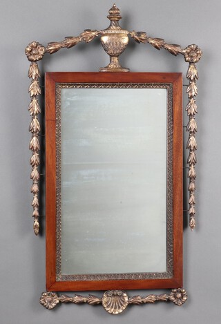 A 19th century Continental rectangular plate mirror contained in a walnut frame surmounted by a carved gilt wood lidded urn with swags to the side 80cm h x 46cm w 