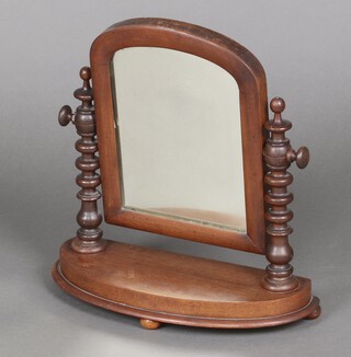 A Victorian arched plate dressing table mirror contained in a mahogany swing frame supported by spiral columns on a bow front base 43cm h x 41cm w x 17cm d 