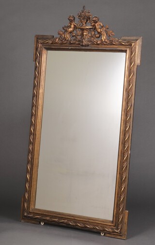 A 19th century Continental rectangular plate mirror contained in a gilt plaster frame surmounted by 2 seated cherubs 153cm h x 87cm w 