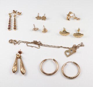 Six pairs and one odd 9ct gold earring (some a/f, one pair set red stones), together with a 9ct gold chain hung a B pendant, 5.1g gross, excluding stone set earrings which are 1.9g 