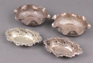 An Edwardian pierced silver dish, Chester 1902, 34g, a similar silver plated dish and 2 Eastern embossed metal dishes decorated elephants 