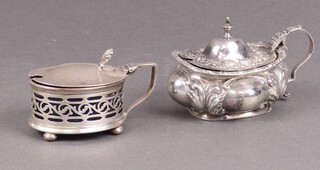 An embossed silver mustard pot with blue glass liner, Birmingham 1903, marks rubbed and 1 other Birmingham 1946, 93g