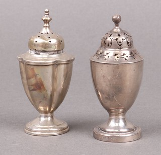 Two Georgian style silver pepperettes of baluster form on spreading feet, marks rubbed, 81g 