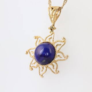 A gold marked 750 chain 2.2g, hung a pendant set a blue hardstone 2.5g