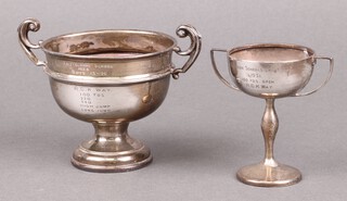 A silver twin handled trophy cup with inscription,  Birmingham 1902, 8cm, (the base is weighted and misshapen), together with a silver twin handled trophy cup Birmingham 1929 