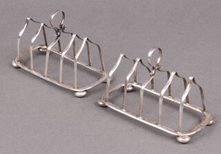 A pair of Edwardian silver 5 bar toast racks, raised on bun feet, Birmingham 1908 by Joseph Gloster, 109 grams 