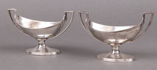 A pair of Georgian silver twin handled oval salts with armorial decoration, on spreading feet, London 1797 by John Emes, 192g 
