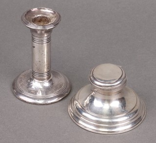 A silver stub shaped candlestick Birmingham 1908, 10cm (heavily dented) and a silver capstan inkwell Birmingham 1912 9cm (hinge a/f, dented and weighted) 
