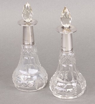 A pair of cut glass and silver club shaped perfume bottles Birmingham 1925 by Mappin & Webb, 19cm 