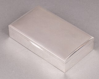 A silver cigarette case with engine turned decoration Birmingham 1971 by Robert Dore Ltd., 3cm x 15cm x 8cm 