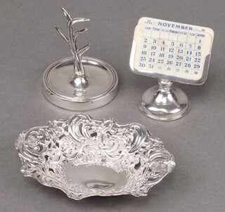 A Victorian pierced silver bowl Sheffield 1894 by R F Mosley & Co., 37g, a silver ring tree Birmingham 1909, together with a perpetual calendar London 1922, complete with 4 double sided sets of months and 4 celluloid double sided sets of dates (slight dents to top, marks rubbed) 