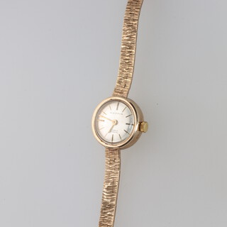 Mappin, a lady's wristwatch with silvered dial, gilt batons, the movement marked 17 jewels Swiss, contained in a 9ct gold case with integral bracelet, the back inscribed for long service, 11g gross  
