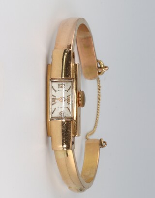 A lady's Excellent wristwatch with rectangular dial and gilt numerals, the movement unsigned, contained in an 18ct gold case with integral bangle bracelet, 10g (excluding movement but including glass) 