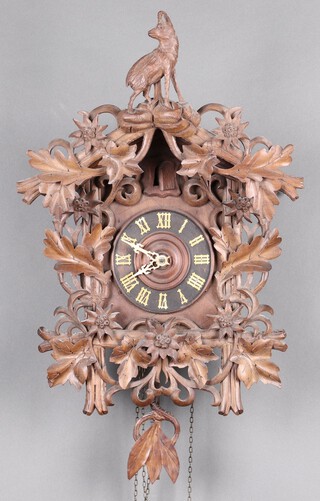 A Swiss carved cuckoo clock with pendulum (no weights) 56cm h x 35cm w