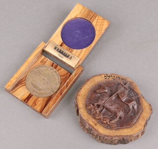 A Masonic circular olive wood plaque, carved The Lamb of God and with Hebrew characters 11cm diam. together with a Masonic bronze medallion - Grand Lodge of The State of Israel 1953 - 1978 Jerusalem City of Peace, contained in a olive wood case  