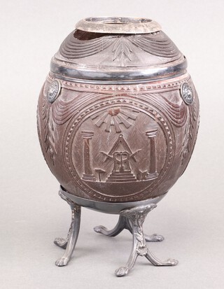 An 18th/19th century Masonic carved coconut shell, the bowl carved fruit, square, compasses, pillars, radiant sun, pedestal and flaming heart, raised on a circular base, 16cm 