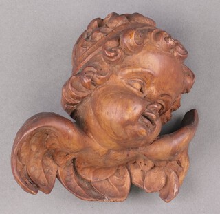 A carved lime wood bust of a cherub 11cm, with old label to the back dated 13.6.50 