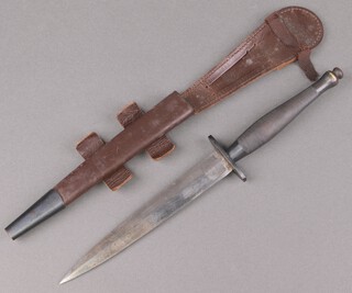 A Wilkinson type III Second Pattern Fairbairn Sykes fighting dagger, the 17cm blade etched "The F-S Fighting Knife" and "Wilkinson Sword London" Verso, complete with leather scabbard 