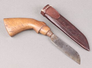 Carl Schlieper, a German pruning knife with 11cm blade marked Solingen German with wooden pistol grip, contained in a leather scabbard marked 1612 50LP Perak 