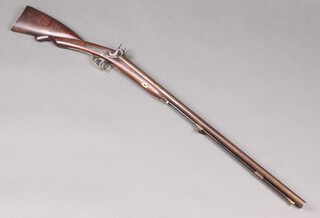 A 19th Century muzzle loading double barrelled percussion hammer shot gun with 76cm Damascus barrels, walnut stock with brass butt plate, foliate engraved hammers trigger guard and lock plate. brass capped wooden ramrod.
