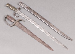 A chassepot bayonet the blade marked 1872 complete with scabbard, together with a short sword with 41cm blade and wooden chequer grip 