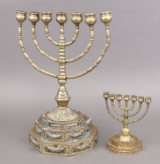 A brass menorah raised on an octagonal stepped base 39cm h x 28cm w, together with 1 other 16cm h x 10cm w   