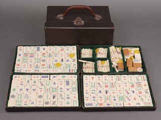 A bone and bamboo Mahjong set contained in a 4 drawer fibre carrying case 