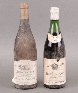 A bottle of Chablis 1er Cru Beauregards 2000 white wine and a bottle of Tigne Rouge wine 1975