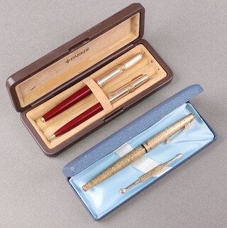 Parker for Shell Oil, a red fountain pen with gilt mount together with a ditto propelling pencil, cased, a lady's Sheaffer fountain pen with 14ct gold nib, cased 
