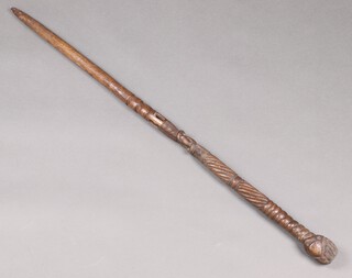 An African Mende carved wooden staff with mask head spiral turning, the centre fitted a ball 119cm long 