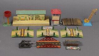 A collection of O gauge buildings and track accessories to include level crossing, buffers, platform, water tower, etc 