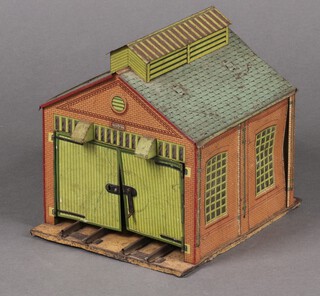 A Hornby Meccano O gauge pressed metal train depot featuring track and folding doors together with a collection of clockwork locomotives, wagons, rolling stock, stock tanks, track etc  