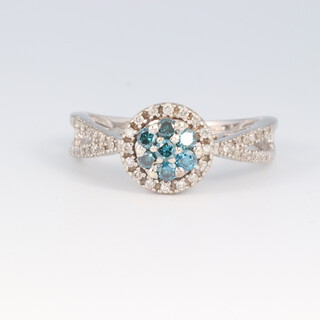 A 9ct white gold, blue and white diamond set cluster ring, the shoulders each set 2 rows of diamonds, size P 1/2, 3.4g