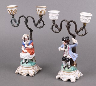 A pair of 19th century Continental porcelain and gilt metal twin light candelabrum supported by seated figures 22cm