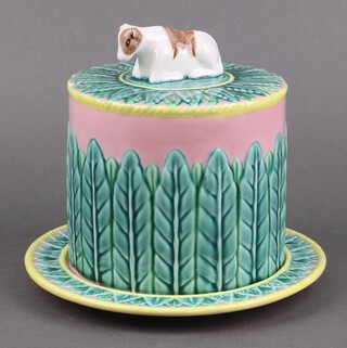 A Majolica style pink and green glazed cheese dish and cover, the lid decorated a seated cow 21cm 