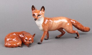 A Beswick model of a fox 13cm and a curled fox 1017 