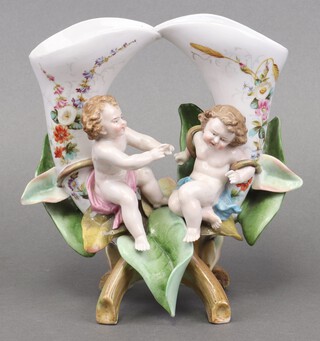 A Meissen style vase in the form of 2 cornucopias supported by cherubs, the base with stylised crossed sword mark impressed 42, 19cm 