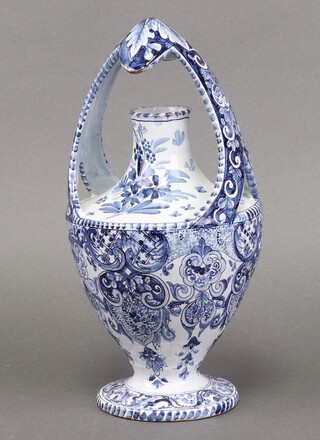 A 19th century Delft pottery flask of baluster form raised on a spreading foot 28cm 