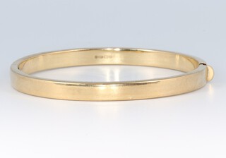 A 9ct gold bangle, 6.5cm wide, 10.8g
