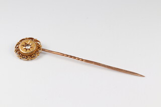 A gold testing as 14ct tie pin (misshapen) set a diamond 