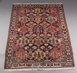 A brown, green and blue ground Persian floral patterned rug within a 3 row border, 195cm x 141cm 