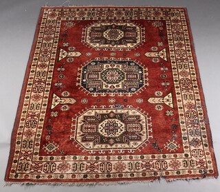 A brown and cream ground Turkish rug with 2 octagons to the centre within a 3 row border 203cm x 161cm 
