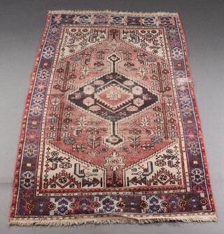 A red blue and white Afghan rug with central medallion within a multi row border 191cm x 124cm 